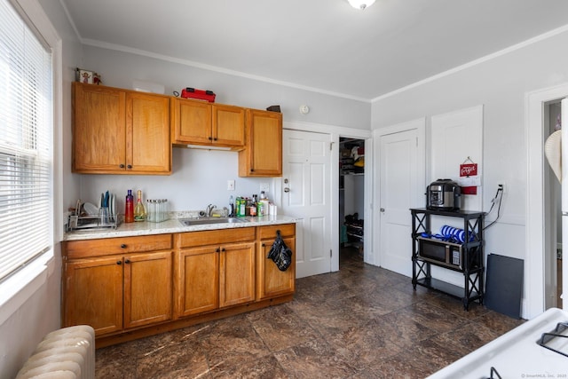 1909 Broad St, Hartford, CT 06114 - kitchen with light countertops, a sink, brown cabinets, and radiator