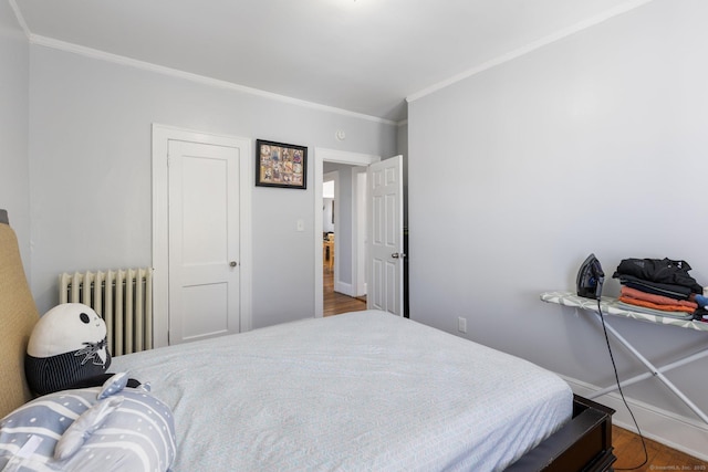 1909 Broad St, Hartford, CT 06114 - bedroom featuring radiator, baseboards, crown molding, and wood finished floors