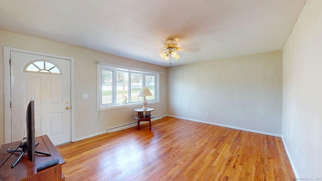 entryway with baseboards, a ceiling fan, light wood finished floors, and baseboard heating