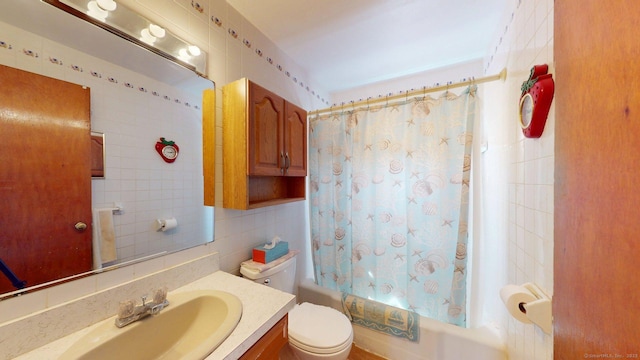 bathroom with vanity, toilet, tile walls, shower / tub combo, and backsplash