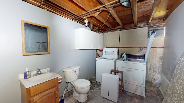 bathroom featuring vanity, toilet, concrete floors, and independent washer and dryer