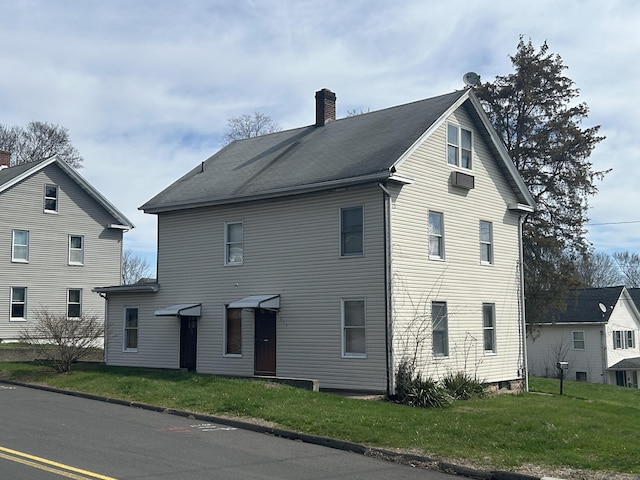 209 W Center St, Southington, CT 06489 - back of property with a chimney and a lawn