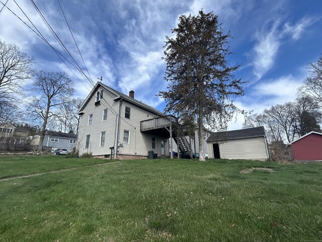 209 W Center St, Southington, CT 06489 - view of front of home featuring a front yard, a chimney, a wooden deck, and stairs