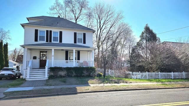 traditional style home with covered porch and fence