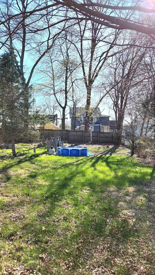 view of yard featuring a fenced backyard and a swimming pool