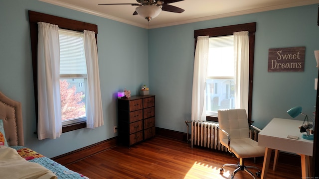 office featuring a ceiling fan, wood finished floors, a healthy amount of sunlight, and ornamental molding