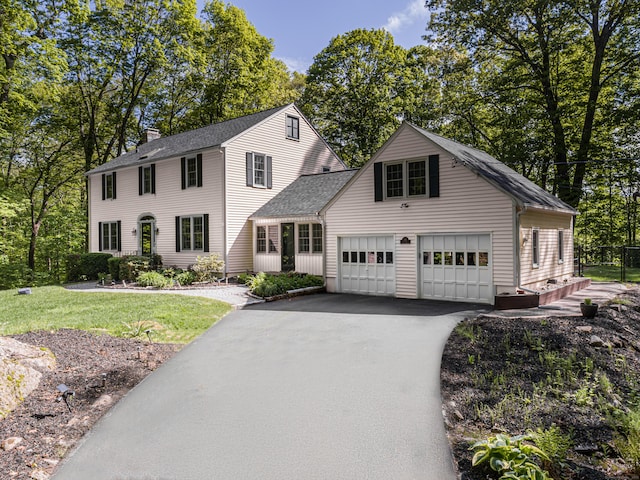 20 Linden Rd, Ridgefield, CT 06877 - colonial-style house with a chimney, a garage, roof with shingles, driveway, and a front yard