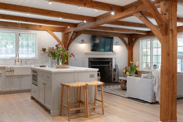 8 Twixt Rd, Cornwall, CT 06753 - kitchen with open floor plan, healthy amount of natural light, light wood-style floors, and beamed ceiling