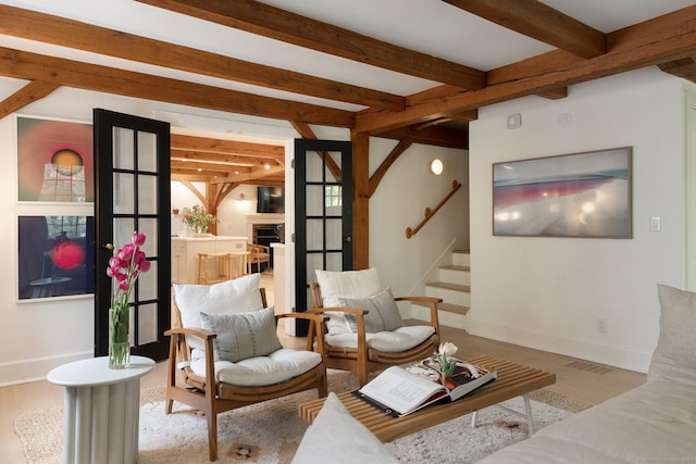 8 Twixt Rd, Cornwall, CT 06753 - living area featuring stairway, beamed ceiling, wood finished floors, and baseboards