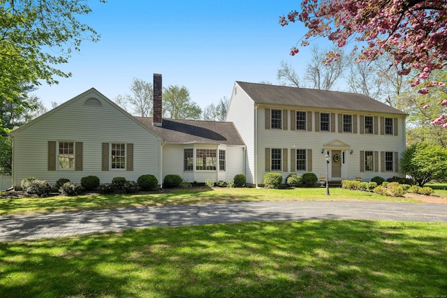 7 Tunxis Trl, Redding, CT 06896 - colonial inspired home with roof with shingles, a chimney, and a front yard