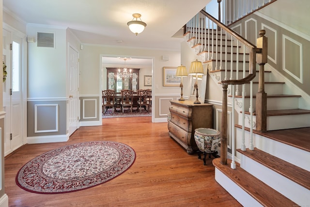 7 Tunxis Trl, Redding, CT 06896 - entryway with stairway, a decorative wall, wood finished floors, and visible vents