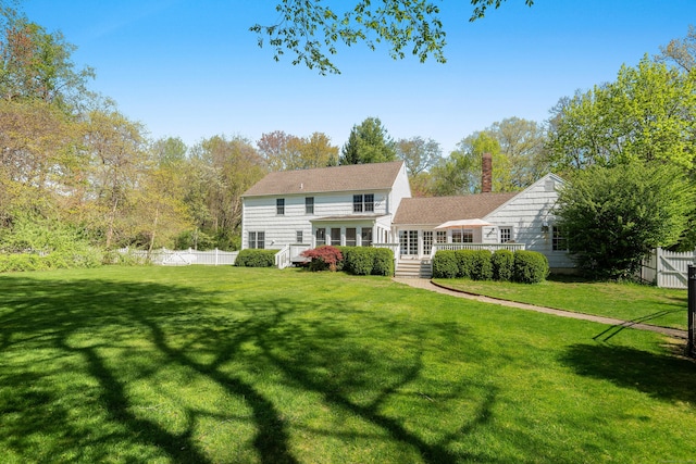 7 Tunxis Trl, Redding, CT 06896 - rear view of house featuring a yard, a chimney, and a fenced backyard