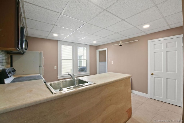 10 Silver St, Middletown, CT 06457 - kitchen with a sink, stove, light countertops, light tile patterned flooring, and a paneled ceiling