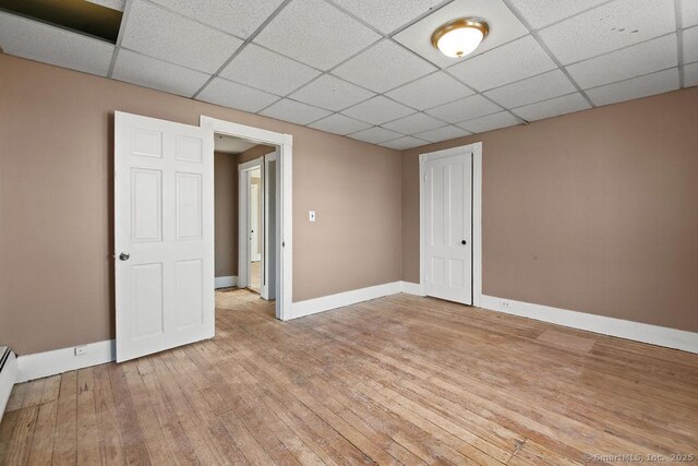 10 Silver St, Middletown, CT 06457 - spare room with light wood-style floors, baseboards, a drop ceiling, and a baseboard radiator