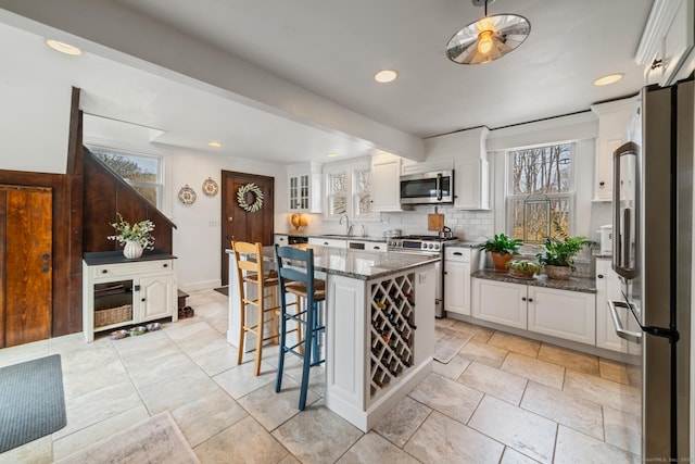 329 Weekeepeemee Rd, Woodbury, CT 06798 - kitchen with a sink, appliances with stainless steel finishes, dark stone countertops, and white cabinetry