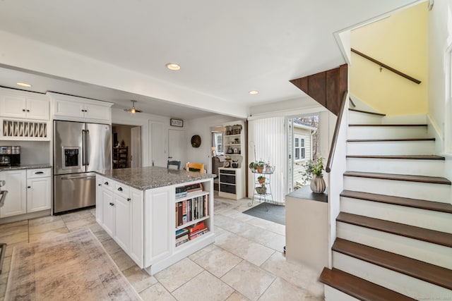 329 Weekeepeemee Rd, Woodbury, CT 06798 - kitchen with stainless steel fridge with ice dispenser, recessed lighting, white cabinetry, dark stone counters, and a kitchen island