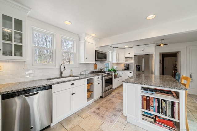 329 Weekeepeemee Rd, Woodbury, CT 06798 - kitchen with white cabinets, dark stone counters, decorative backsplash, premium appliances, and a sink