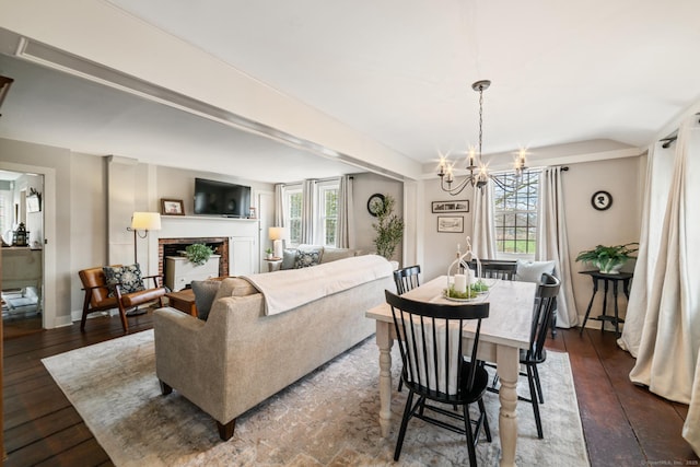 329 Weekeepeemee Rd, Woodbury, CT 06798 - dining area with a wealth of natural light, a fireplace, dark wood-type flooring, and an inviting chandelier