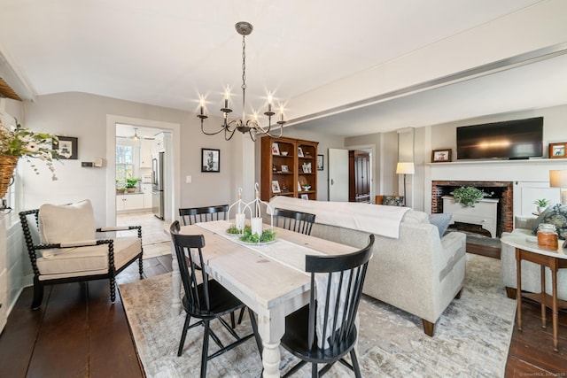 329 Weekeepeemee Rd, Woodbury, CT 06798 - dining space featuring a brick fireplace, an inviting chandelier, and wood finished floors