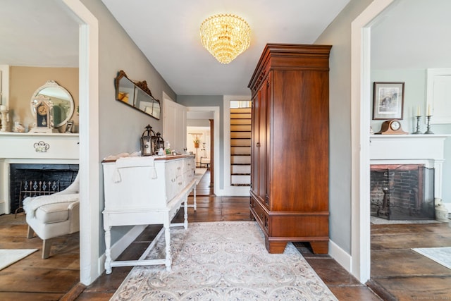 329 Weekeepeemee Rd, Woodbury, CT 06798 - foyer entrance with baseboards, a notable chandelier, a fireplace with flush hearth, and dark wood finished floors