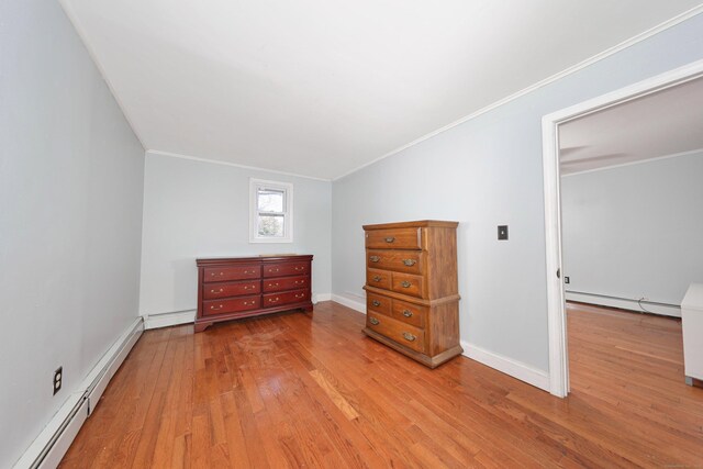 bedroom with crown molding, wood-type flooring, and a baseboard radiator
