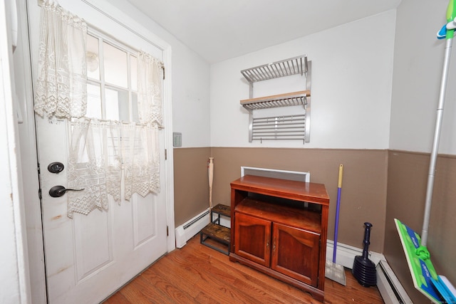 entryway with a baseboard radiator and wood finished floors