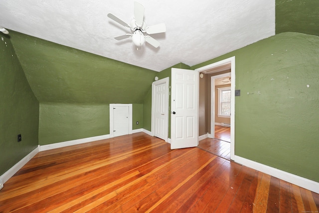 bonus room featuring baseboards, ceiling fan, hardwood / wood-style flooring, baseboard heating, and lofted ceiling