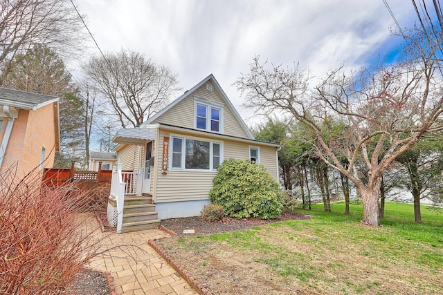 bungalow-style house featuring a front yard