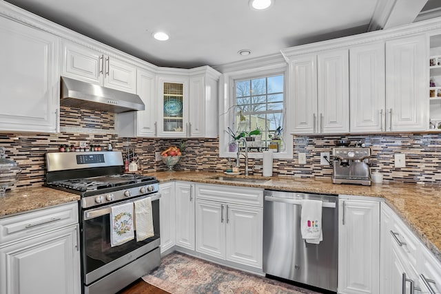 25 Platt Pl, Bridgeport, CT 06606 - kitchen with appliances with stainless steel finishes, under cabinet range hood, white cabinetry, tasteful backsplash, and light stone countertops