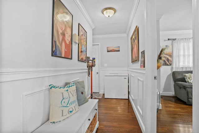 doorway with dark wood-type flooring and ornamental molding