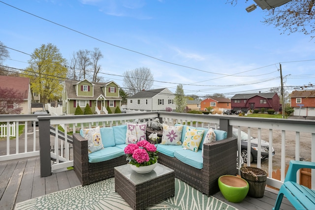 deck with an outdoor living space and a residential view