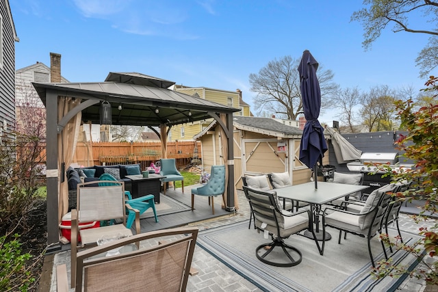 deck with a storage shed, a fenced backyard, a gazebo, outdoor dining area, and an outdoor living space