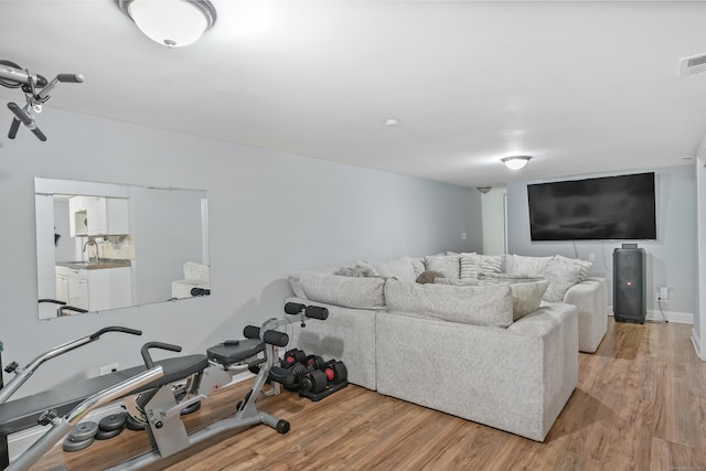living room with light wood-type flooring and visible vents