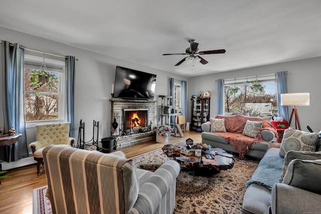 98 Aetna Ave, Torrington, CT 06790 - living area featuring a fireplace, ceiling fan, and wood finished floors