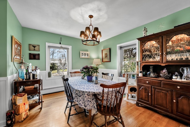98 Aetna Ave, Torrington, CT 06790 - dining space featuring a wainscoted wall, a chandelier, light wood-style flooring, and a baseboard heating unit