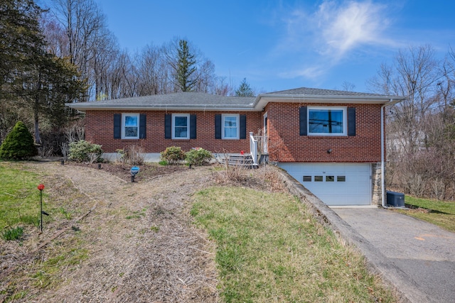 98 Aetna Ave, Torrington, CT 06790 - ranch-style house with brick siding, an attached garage, central AC, a shingled roof, and aphalt driveway