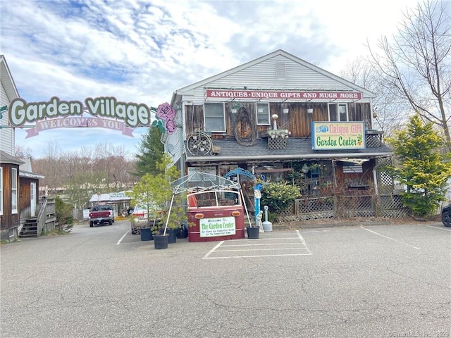 view of building exterior featuring uncovered parking