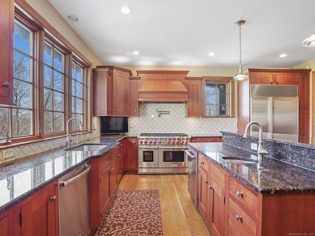 17 Fire Hill Ln, Redding, CT 06896 - kitchen with premium appliances, a sink, premium range hood, light wood-style floors, and recessed lighting