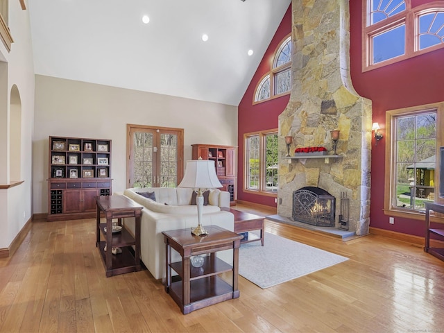 17 Fire Hill Ln, Redding, CT 06896 - living room featuring high vaulted ceiling, wood-type flooring, a fireplace, baseboards, and arched walkways