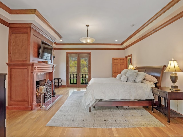 17 Fire Hill Ln, Redding, CT 06896 - bedroom with crown molding, light wood-style flooring, a fireplace with raised hearth, access to exterior, and recessed lighting