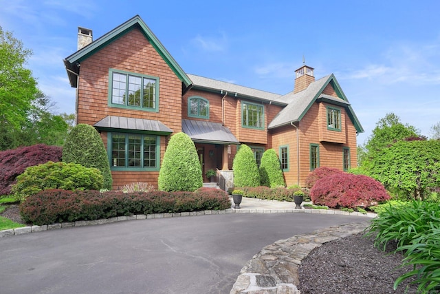 17 Fire Hill Ln, Redding, CT 06896 - view of front of house with a chimney, roof with shingles, and a standing seam roof