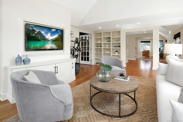 13 Bryan Rd, Norwalk, CT 06853 - living room featuring light wood-style flooring, vaulted ceiling, baseboards, built in shelves, and recessed lighting