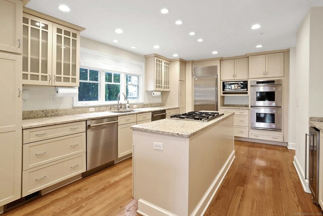 13 Bryan Rd, Norwalk, CT 06853 - kitchen with built in appliances, a center island, a sink, light wood-type flooring, and recessed lighting