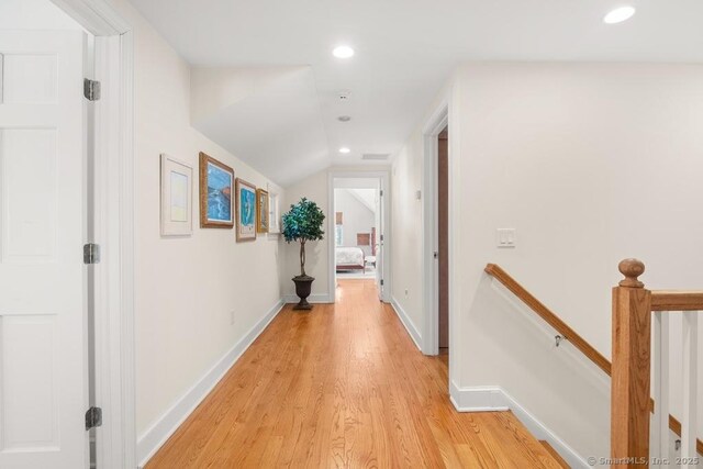 13 Bryan Rd, Norwalk, CT 06853 - hallway with an upstairs landing, light wood-style floors, recessed lighting, lofted ceiling, and baseboards