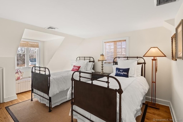13 Bryan Rd, Norwalk, CT 06853 - bedroom featuring multiple windows, wood finished floors, baseboards, and vaulted ceiling