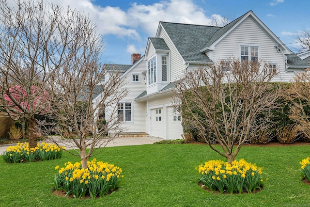 13 Bryan Rd, Norwalk, CT 06853 - back of house with a chimney, a lawn, a shingled roof, and an attached garage
