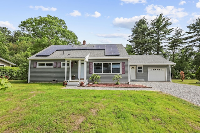 33 Jolley Rd, Plainfield, CT 06239 - view of front of property with a garage, a front lawn, driveway, a chimney, and roof mounted solar panels