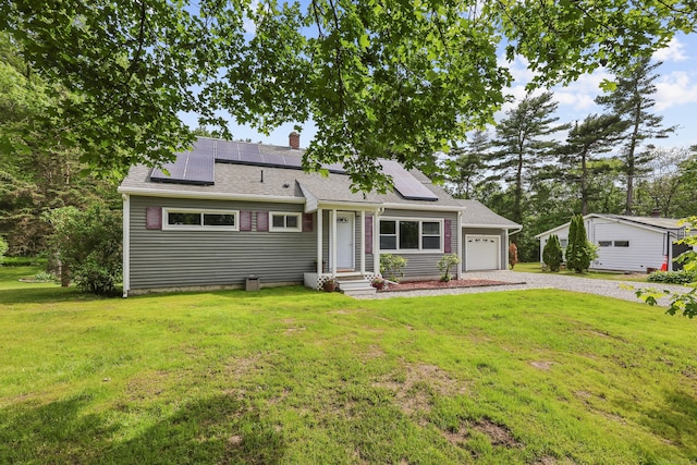 33 Jolley Rd, Plainfield, CT 06239 - view of front of home featuring gravel driveway, a chimney, a front lawn, and roof mounted solar panels