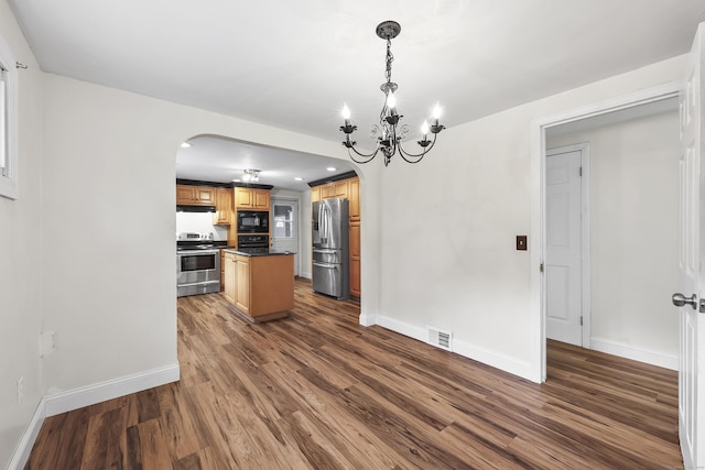 33 Jolley Rd, Plainfield, CT 06239 - kitchen with black appliances, arched walkways, dark countertops, dark wood-type flooring, and a chandelier