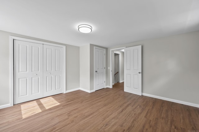 33 Jolley Rd, Plainfield, CT 06239 - unfurnished bedroom with baseboards, wood finished floors, and a closet